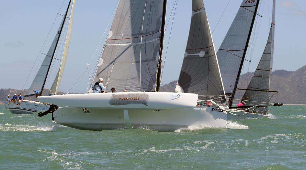 Carbon Credit flying past the monohulls at the top mark © SeaLink Magnetic Island Race Week Media SMIRW